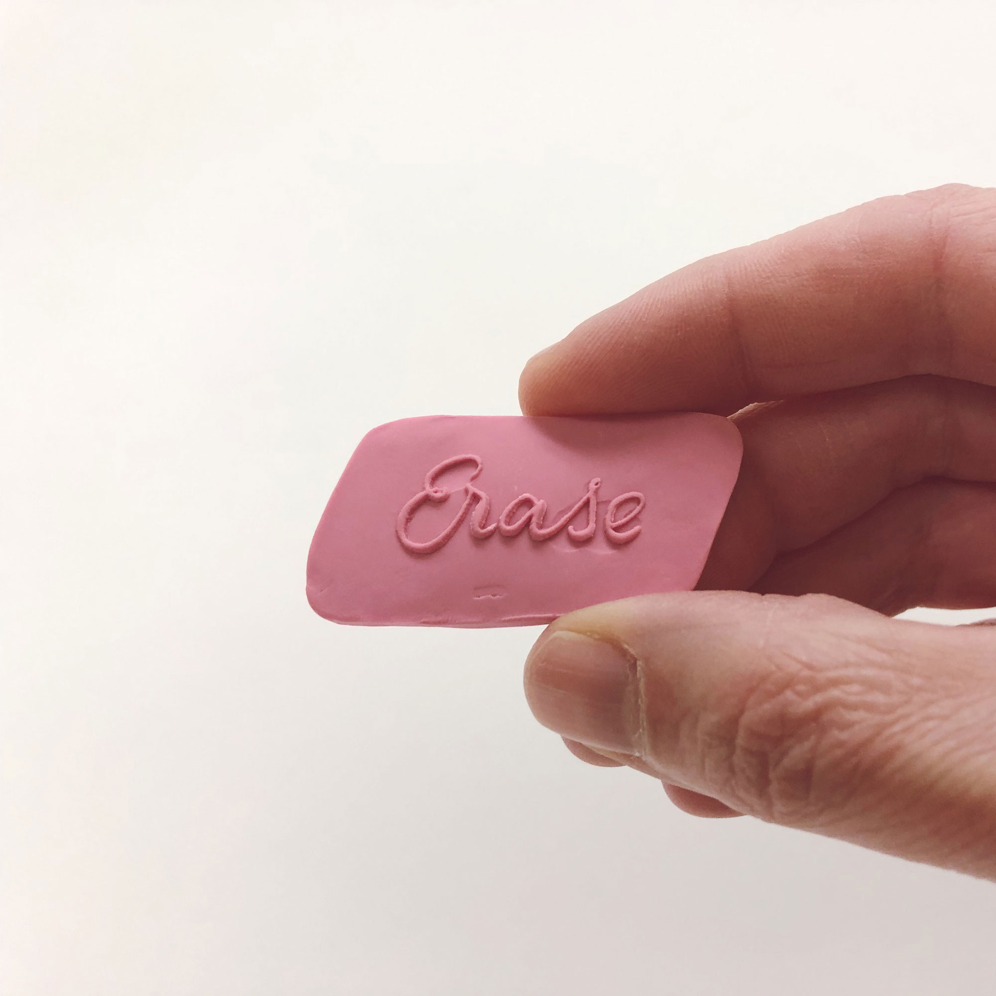 Erase Pink Eraser Pin in hand