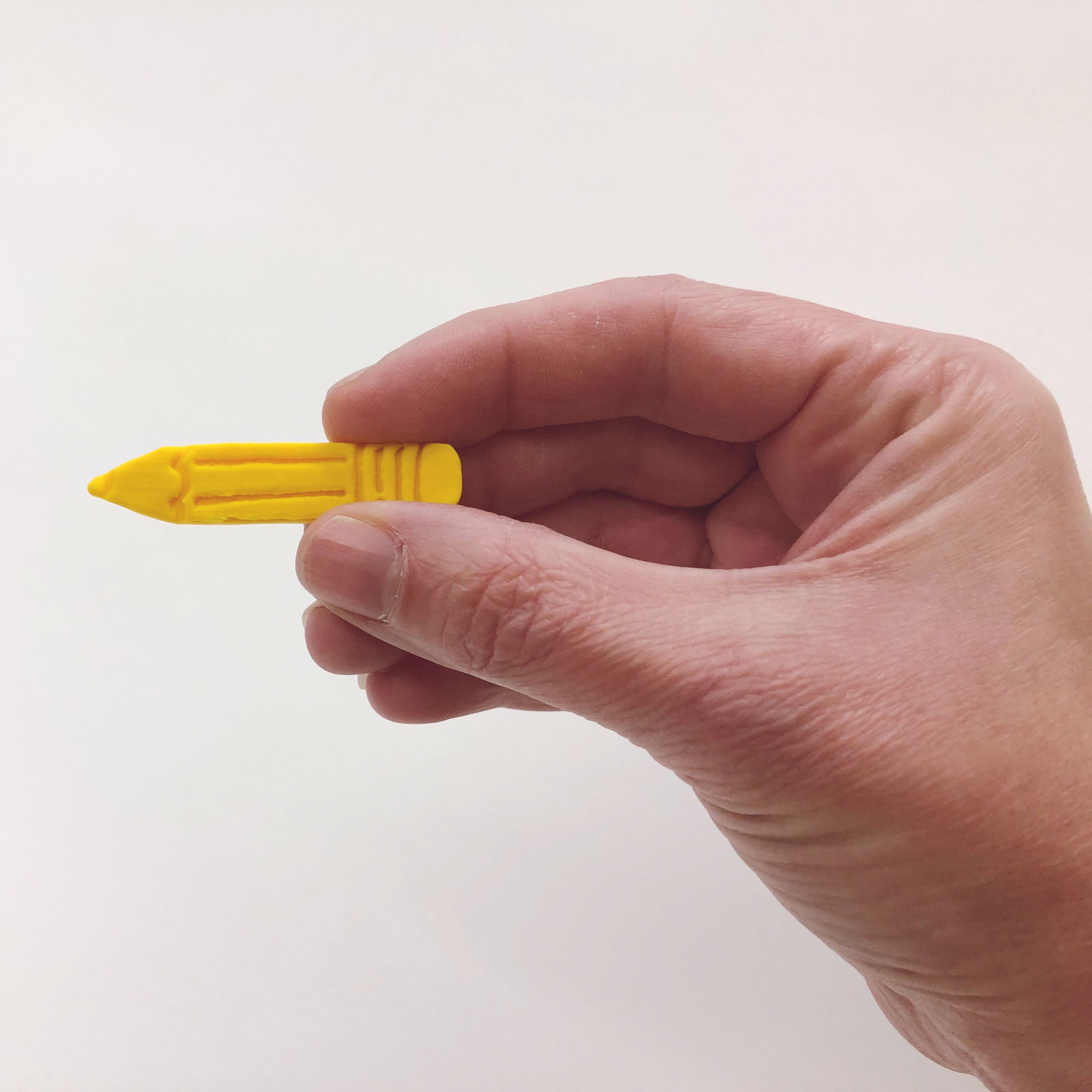 Yellow Pencil Pin in hand